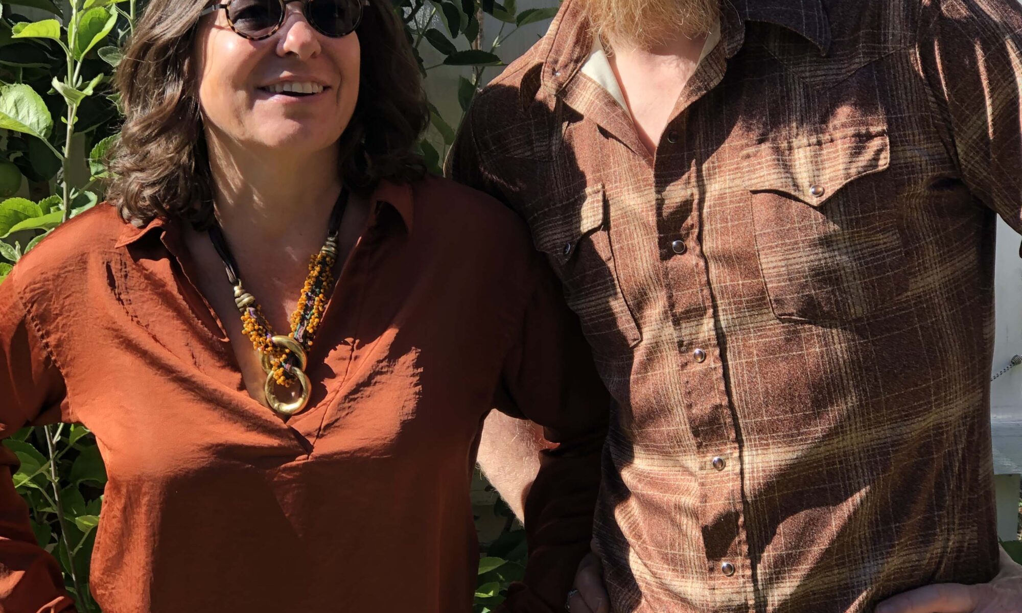 Photo of Jonathan Mack and Lauren Addario wearing rust -colored clothing and posing for a portrait. Photo by Sandra Mack