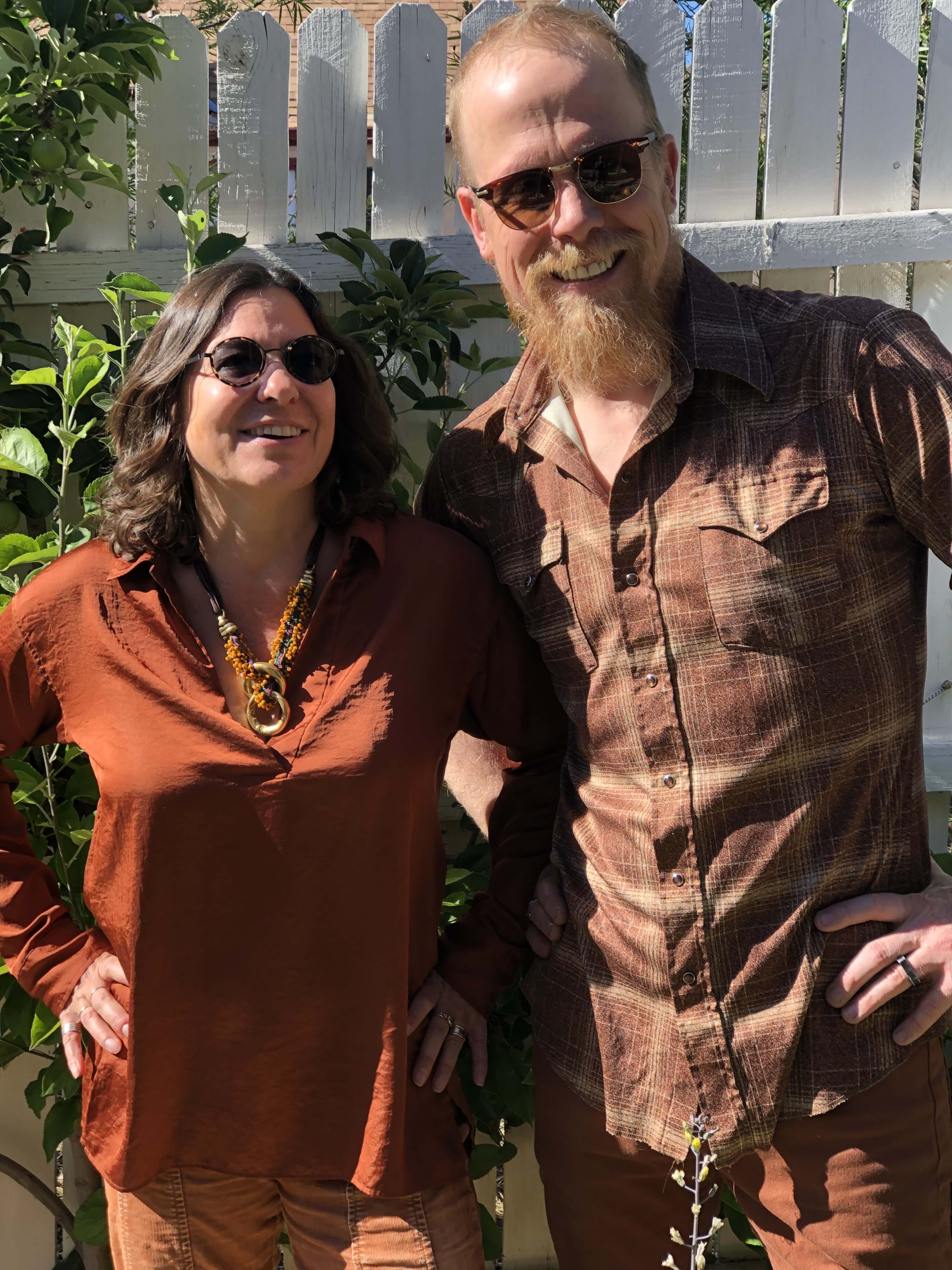 Photo of Jonathan Mack and Lauren Addario wearing rust -colored clothing and posing for a portrait. Photo by Sandra Mack