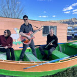 From left, Lauren Addario, Jonathan Mack, John Funkhouser sitting in a rowboat on dry land.