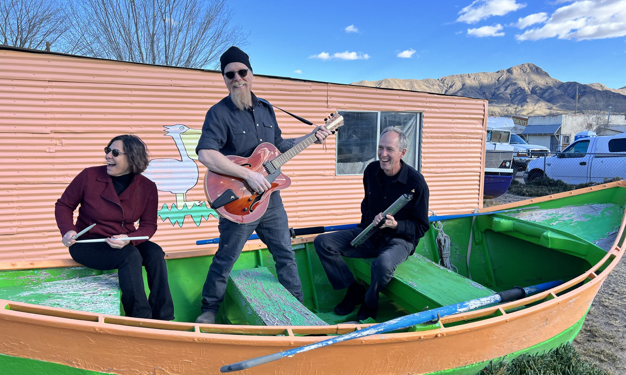 From left, Lauren Addario, Jonathan Mack, John Funkhouser sitting in a rowboat on dry land.