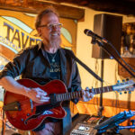 Jonathan Mack playing guitar at the Mineshaft Tavern in Madrid, NM
